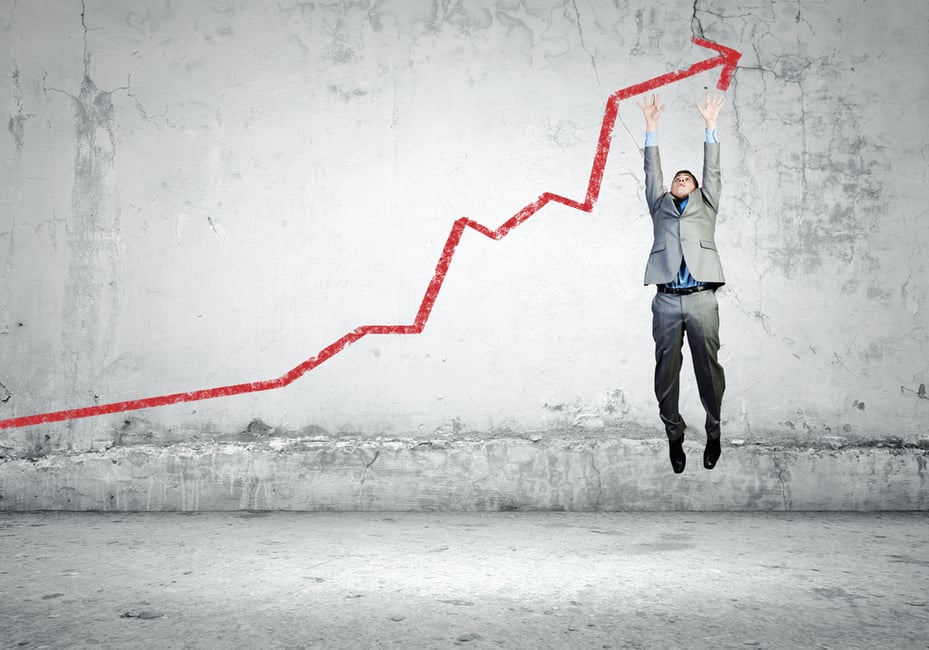 Image of young businessman jumping above graph